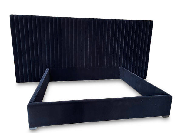 Custom navy bed with large headboard by Rue and Williams