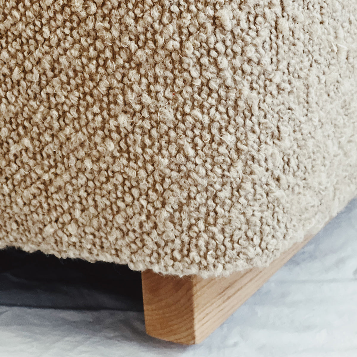 Rue and Williams bottom of boucle chair with wood leg close up