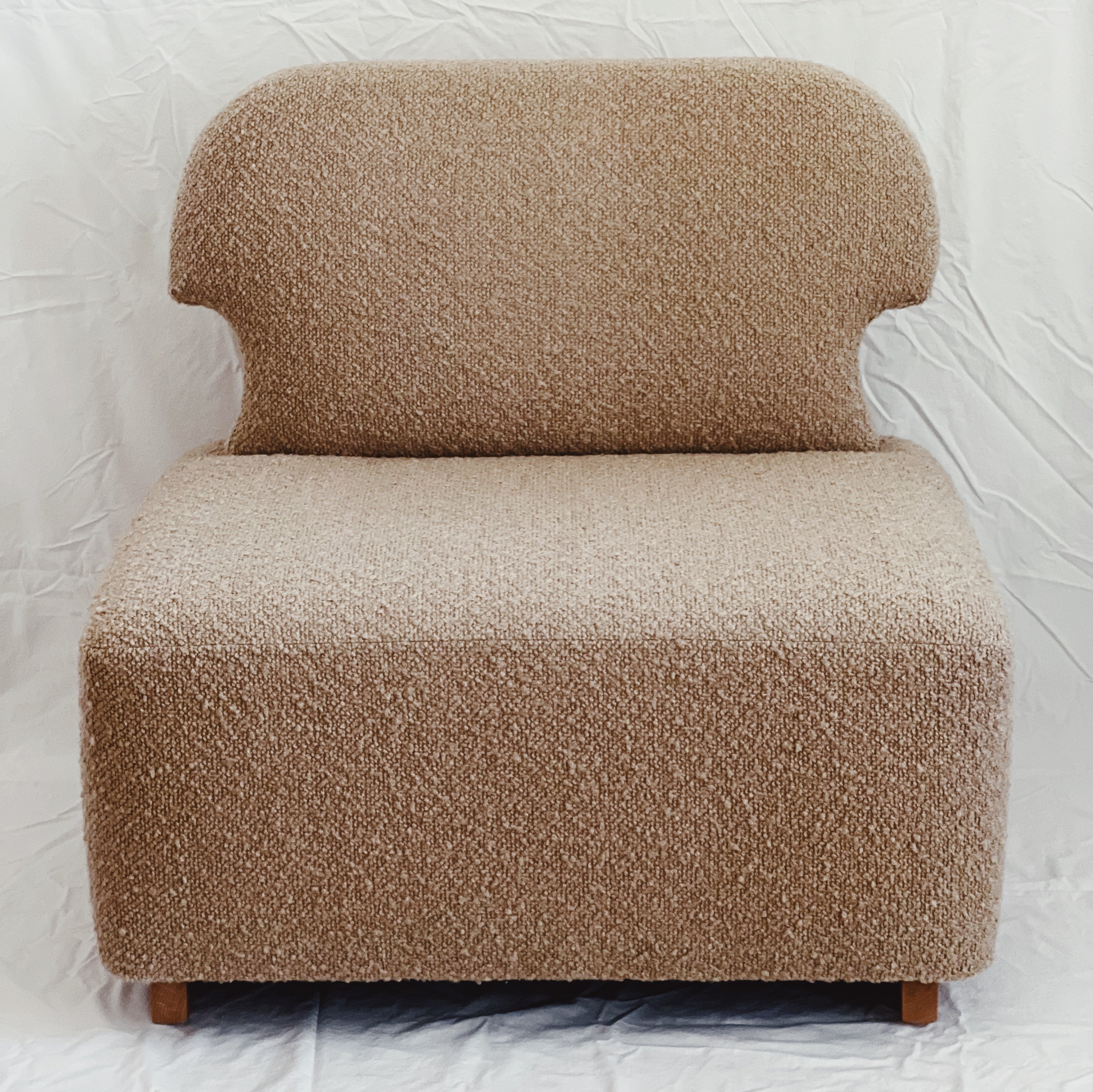 Dune-colored bouclé Meditation Chair by Rue and Williams Home. Modern design with no arms and a curved back, perfect for enhancing mindfulness practices and adding tranquility to any space.